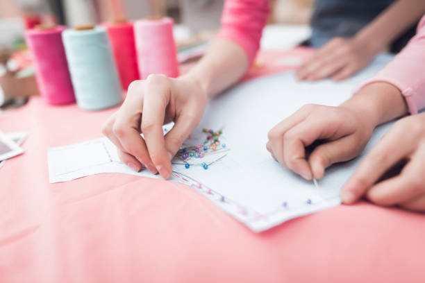 istock A little girl and woman together construct clothes. 942275864