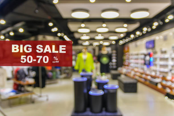 BIG Sale 50-70% off mock up advertise display frame setting over Abstract blurred photo of fashion store in shopping mall which have clothing bag and shoes, shopping concept