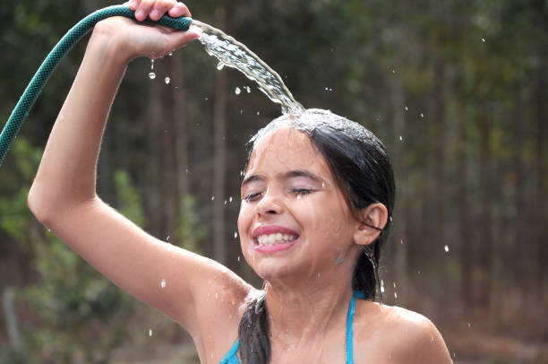 istock girl playing with water 942282310