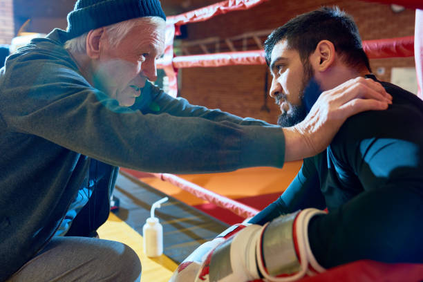 Senior Coach Motivating Young Fighter