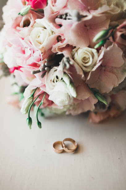 istock Two golden wedding rings isolated background concept 942283304