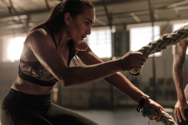 istock Woman doing strength training with battle ropes 942285142