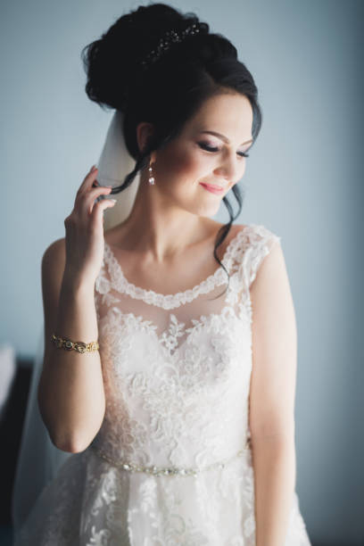 istock Gorgeous bride in robe posing and preparing for the wedding ceremony face in a room 942285816