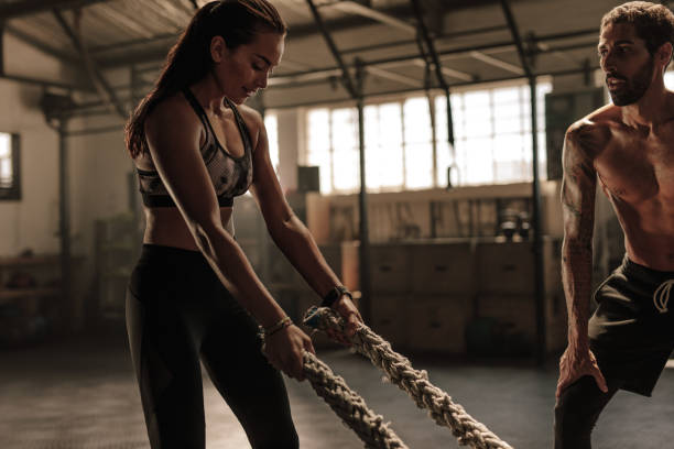 istock Woman at cross training gym with trainer 942286098