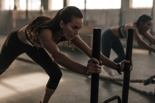 Fit women exercising at cross training gym