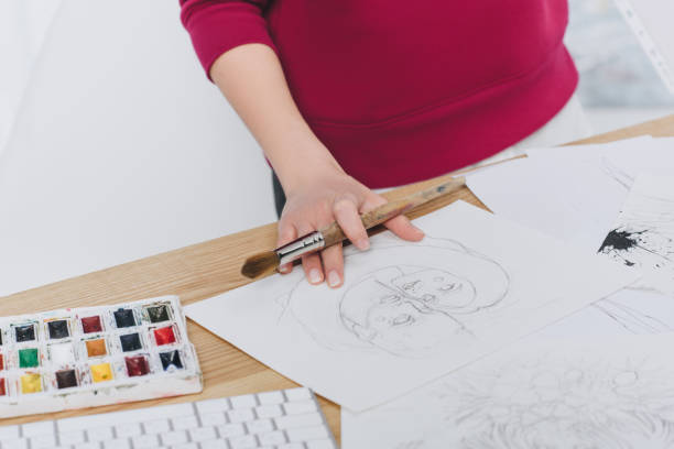 istock Close-up view of woman working on illustrations on working table with computer 942287060