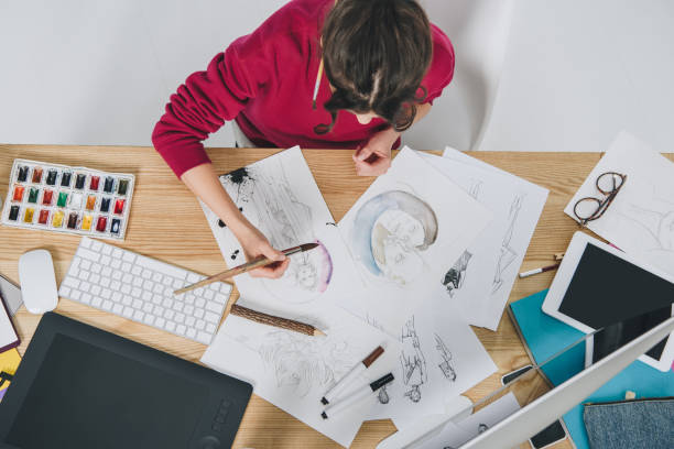 istock Attractive young girl drawing by table with computer 942292872