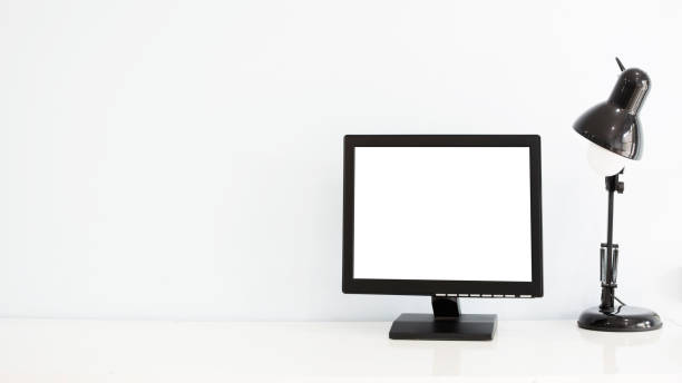 istock Empty white screen and electric lamp placed on office desk. 942296650