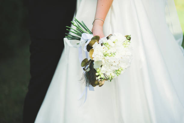 istock Bride holding big and beautiful wedding bouquet with flowers 942297052