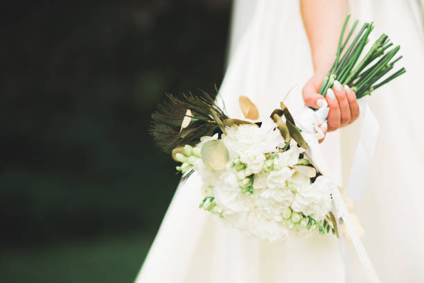 istock Bride holding big and beautiful wedding bouquet with flowers 942297586