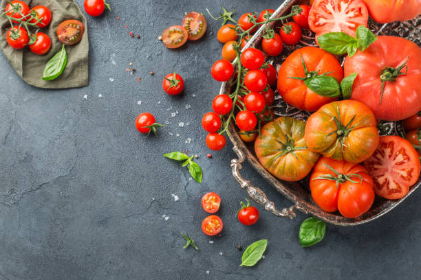Assortment of ripe organic farmer red tomatoes on a table