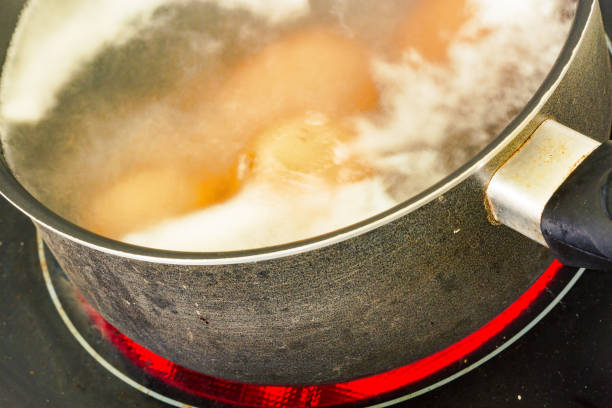 Cooking eggs in a pot of water on a ceramic hob