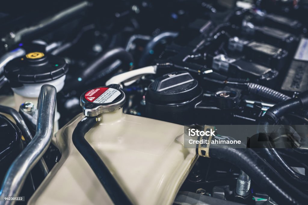Coolant tank and warning information in engine room Car Stock Photo