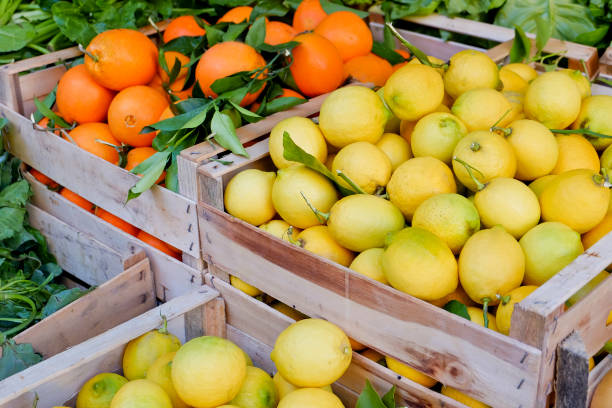 Oranges and lemons in wooden boxes