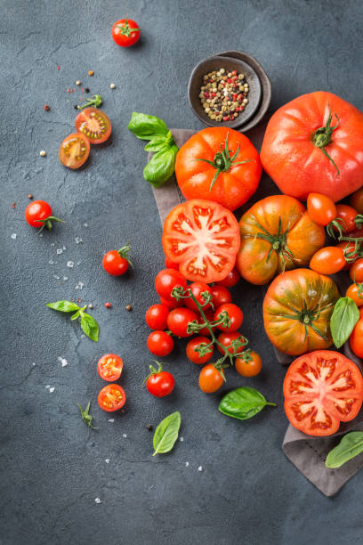 istock Assortment of ripe organic farmer red tomatoes on a table 942304740