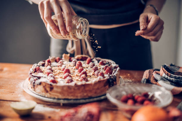 istock Young woman decorating cake 942304964