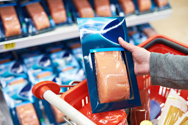 istock Pack of salmon in hand at store 942306320