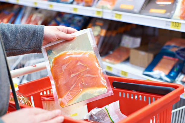 istock Pack of salmon in hand at store 942306430