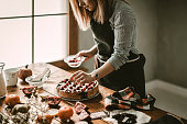 Young woman decorating cake
