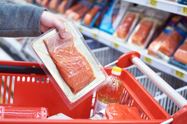 istock Pack of salmon in hand at store 942306650