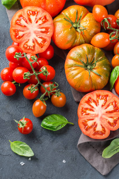 istock Assortment of ripe organic farmer red tomatoes on a table 942309144
