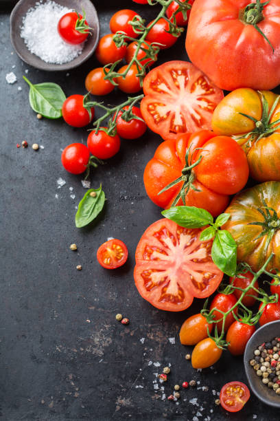 istock Assortment of ripe organic farmer red tomatoes on a table 942309832