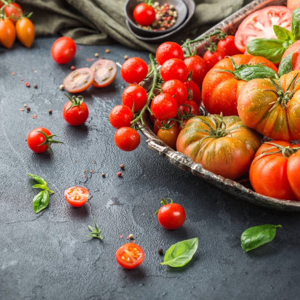 istock Assortment of ripe organic farmer red tomatoes on a table 942310572