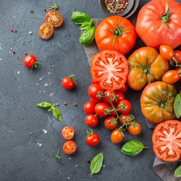 istock Assortment of ripe organic farmer red tomatoes on a table 942313036