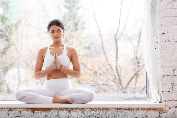 istock Beautiful young woman doing yoga 942313946