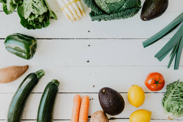 istock Assortment of vegetables on white wooden table 942314022