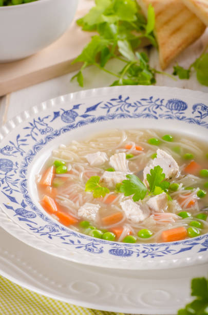 istock Spring chicken soup noodles, vegetable and toast 942314486