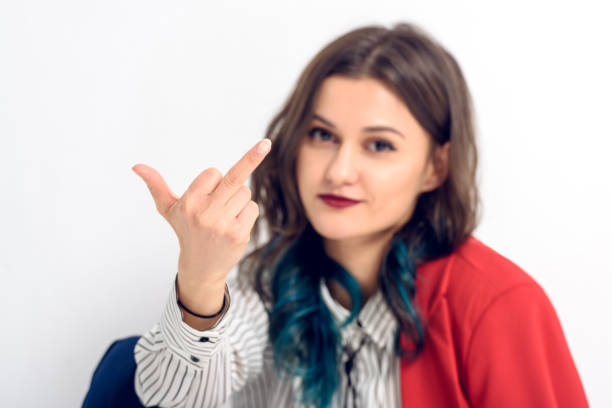 istock Young woman showing middle finger on white background 942314530