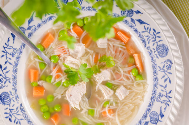 istock Spring chicken soup noodles, vegetable and toast 942314612