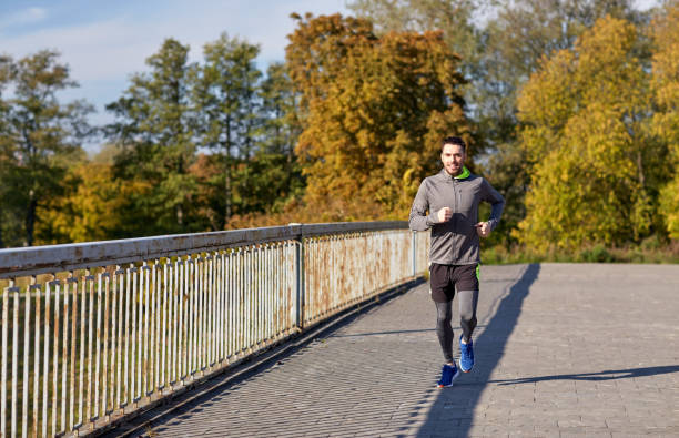 istock happy young man running over city bridge 942317184