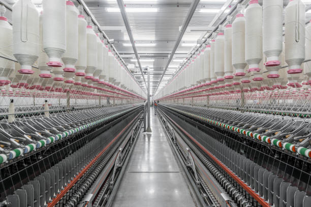 istock spools of thread at a textile factory 942318026