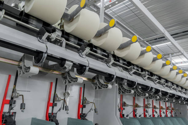 istock spools of thread at a textile factory 942320676