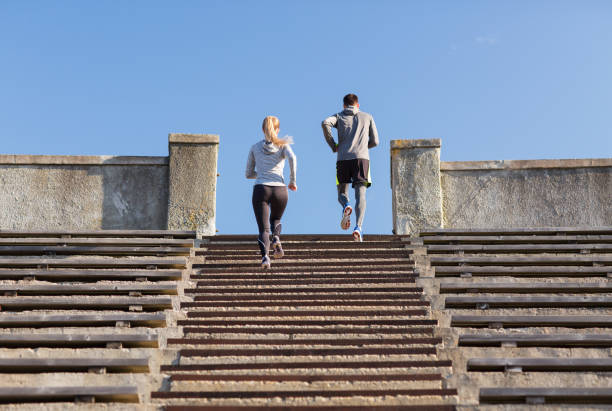 istock couple running upstairs on stadium 942321556