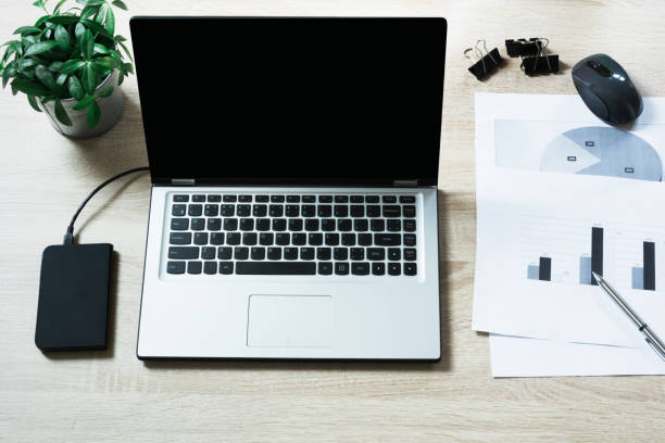 istock Open laptop on office wooden desk table. Top view, copy space. 942322680