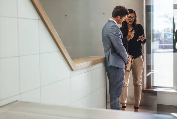 istock business associates discussing work in office stairway 942324796