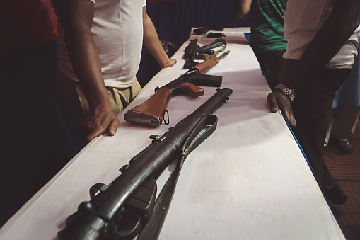 Arms trafficking. different rifles on the counter in the gun shop. clandestine sale of weapons. illegal purchase of weapons. firearms on the table. illegal deal to sell weapons