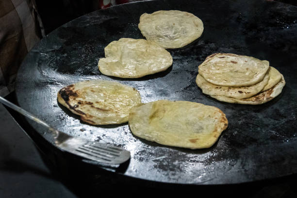istock Making of Roti Canai, Roti cooking process, 942325736