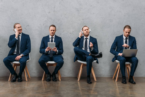 collage of cloned businessman sitting on chairs and using gadgets collage of cloned businessman sitting on chairs and using gadgets cloning photos stock pictures, royalty-free photos & images