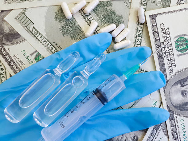 istock gloves dollars capsules syringe 942326584