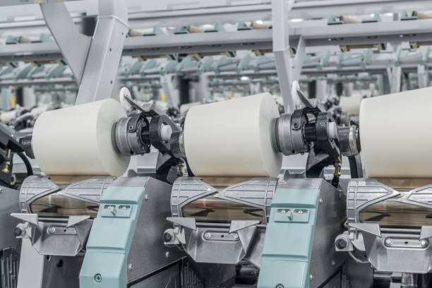 istock spools of thread at a textile factory 942326946