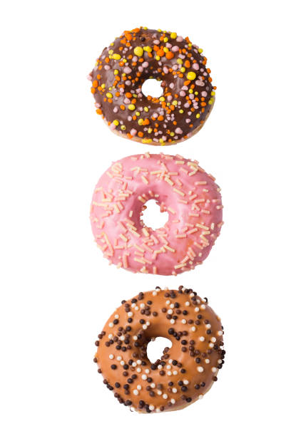 istock Three colorful glazed donuts isolated on white background, top view 942329038