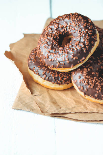 istock Chocolate donuts and coffee , weekend morning table breakfast. Vintage colors. 942329148