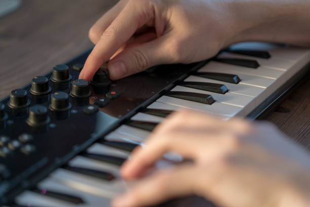 istock Keyboard player is recording song in home studio 942329524