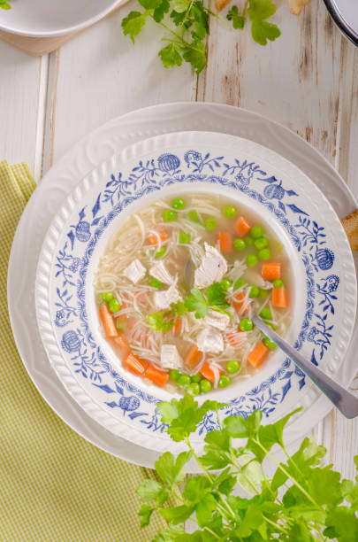 istock Spring chicken soup noodles, vegetable and toast 942330084