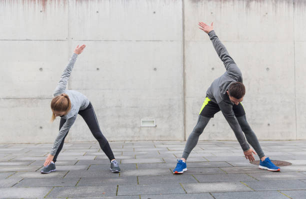 istock couple stretching on city street 942330162