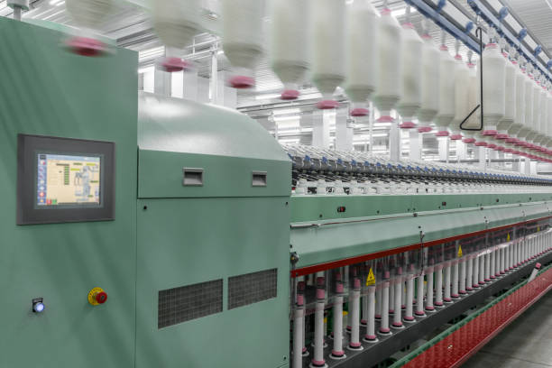 istock spools of thread at a textile factory 942333362